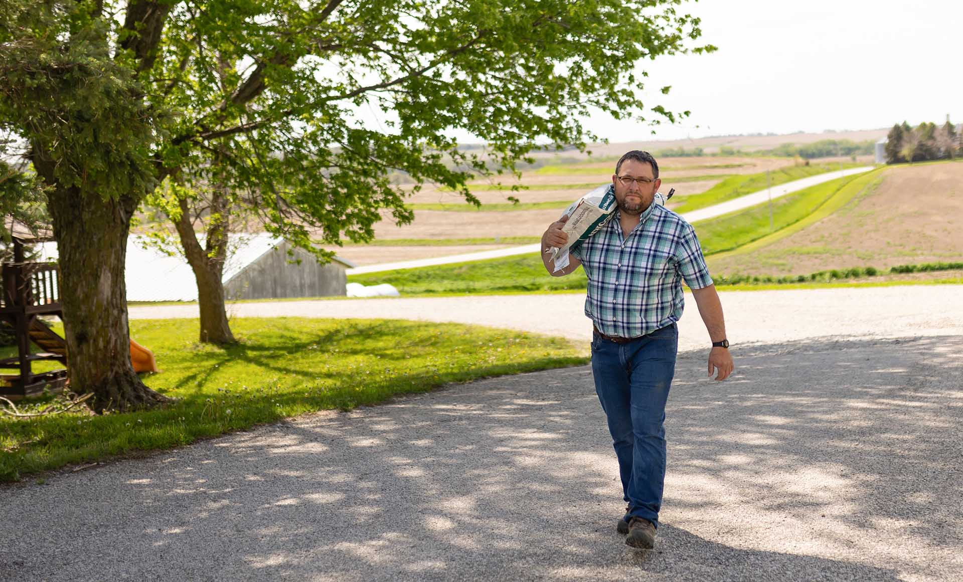 Farmer moving bags of seed