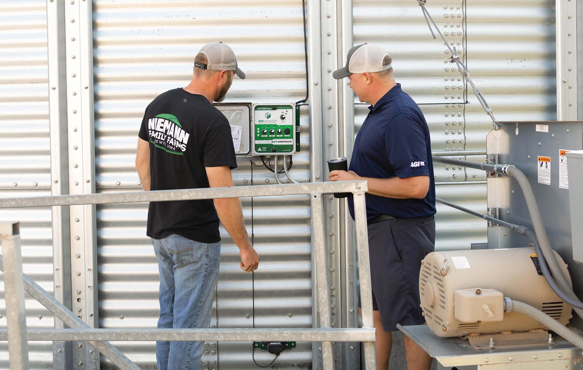 Luke Niemann and Andy McGarry Reviewing settings on grain management system
