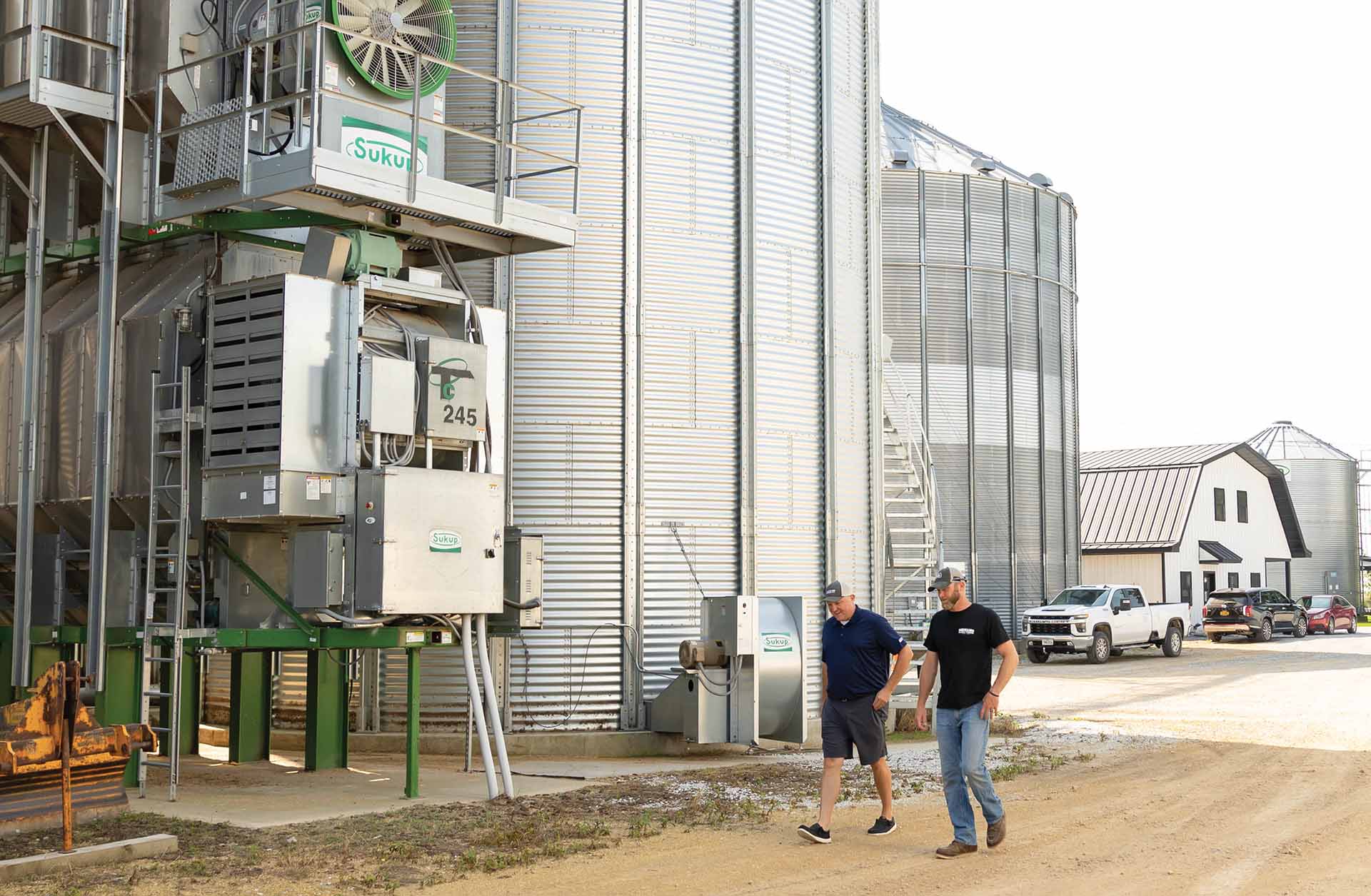 Luke and Andy Ag professionals walking around bins