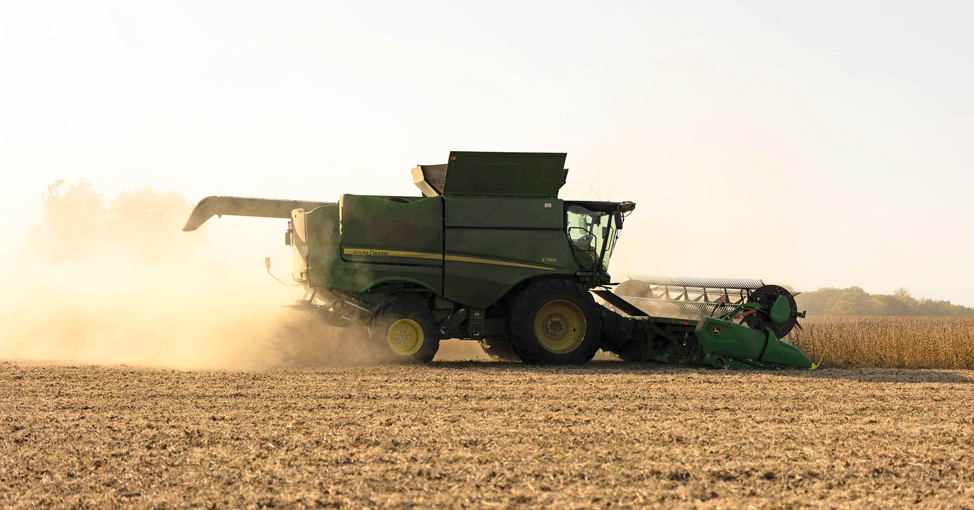 Harvesting Soybeans John Deere combine in soybean field