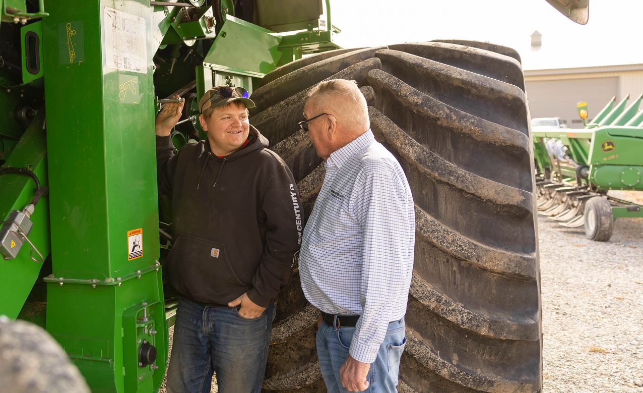 Rolland and Riley Schnell Farmer and his grandson by combine