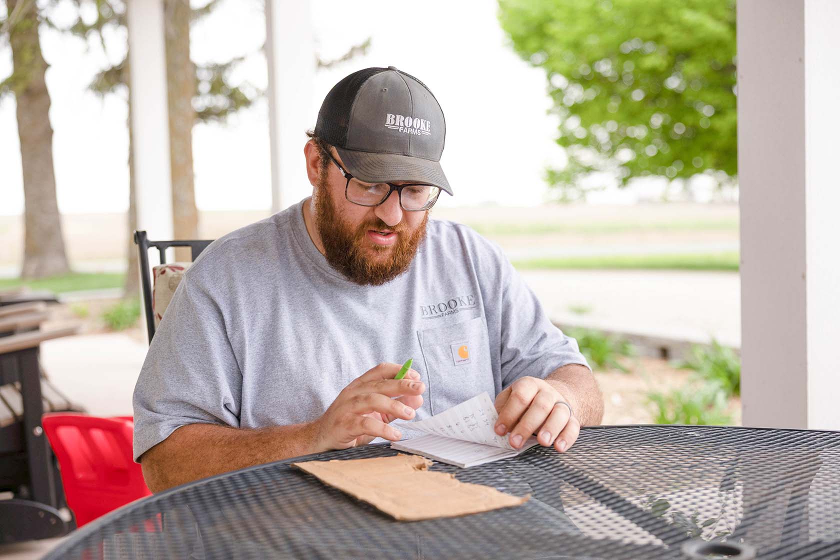 Farmer writes in his notebook.