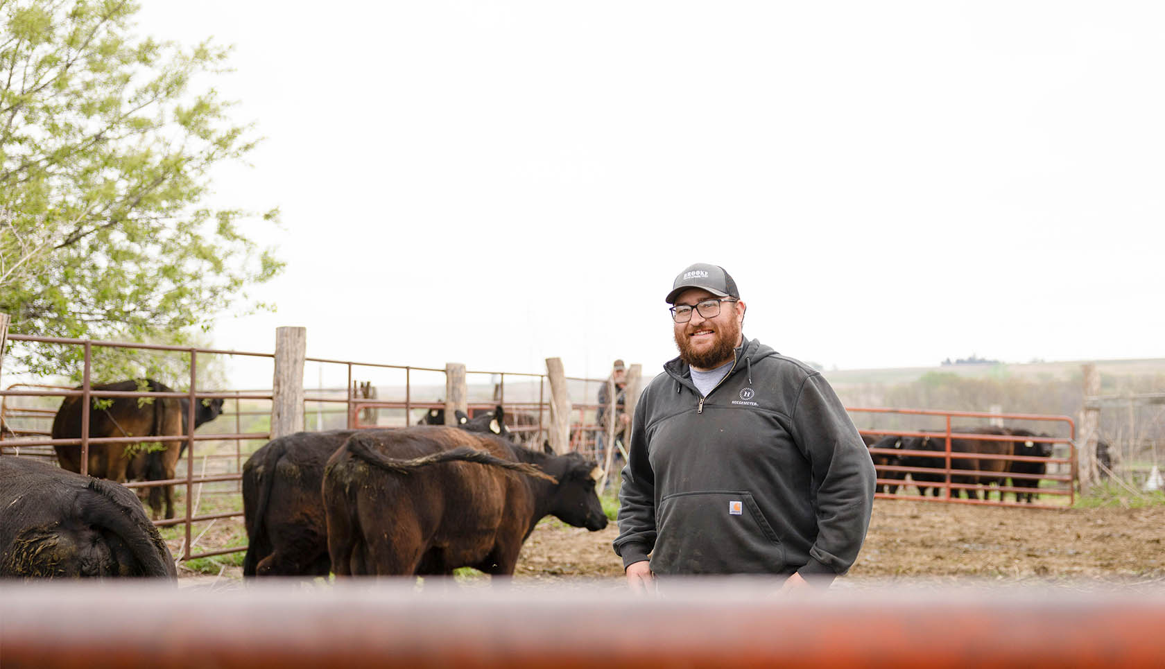 Logan Brooke Farmer posing for picture with cattle