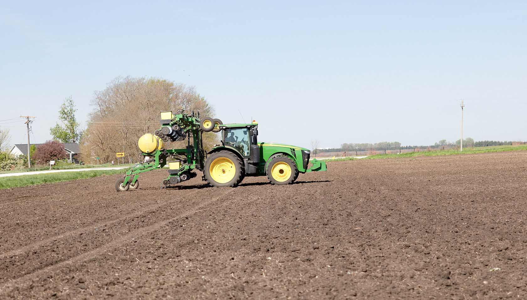 Tim Couser Planting John Deere tractor in field