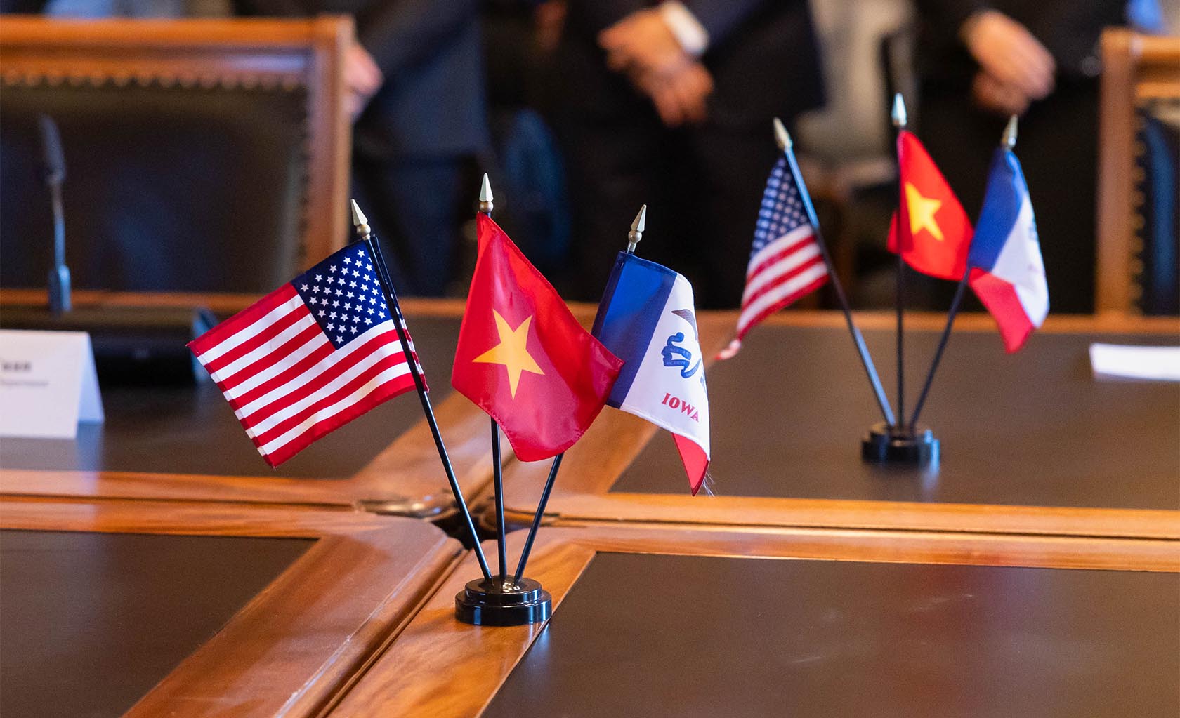 United States, Vietnam and Iowa flags on a table in the