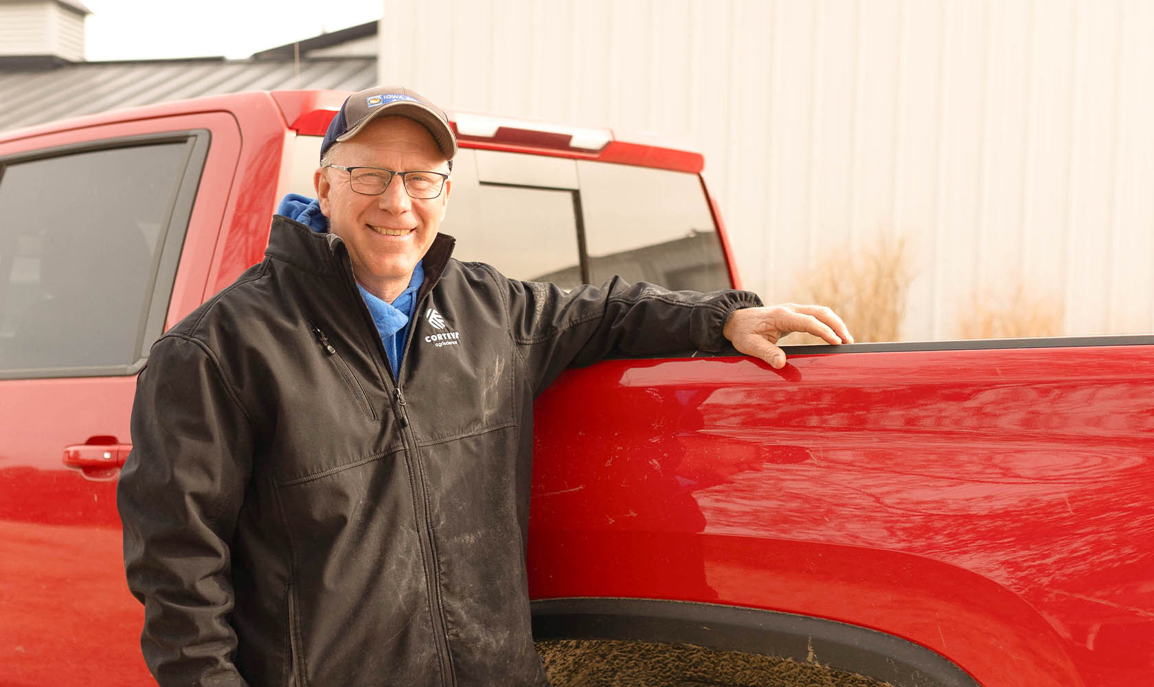 Joe Shirbroun Iowa farmer leaning against red truck