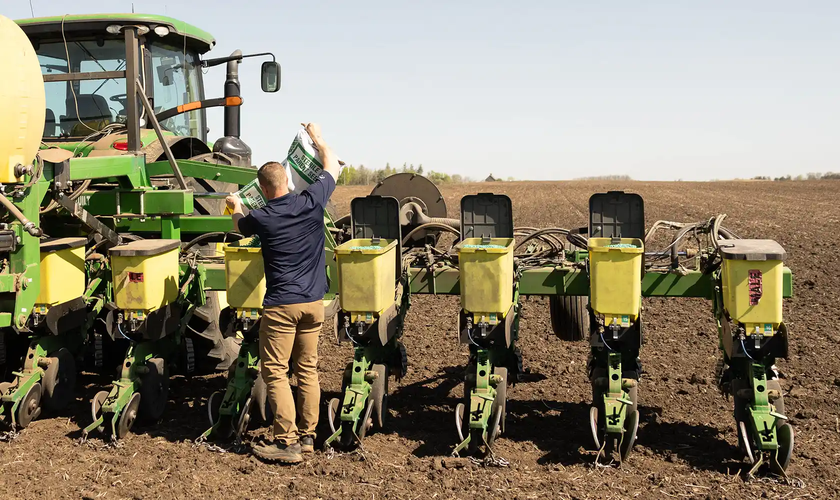 Farmer filling planter with seed