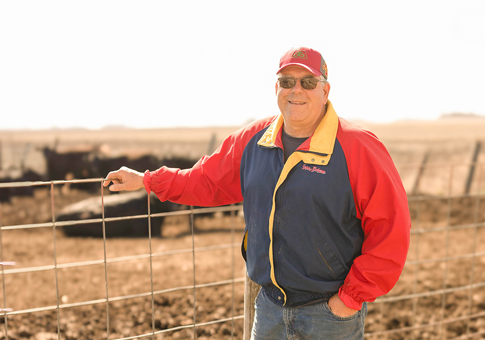 Farmer standing next to cattle in Iowa