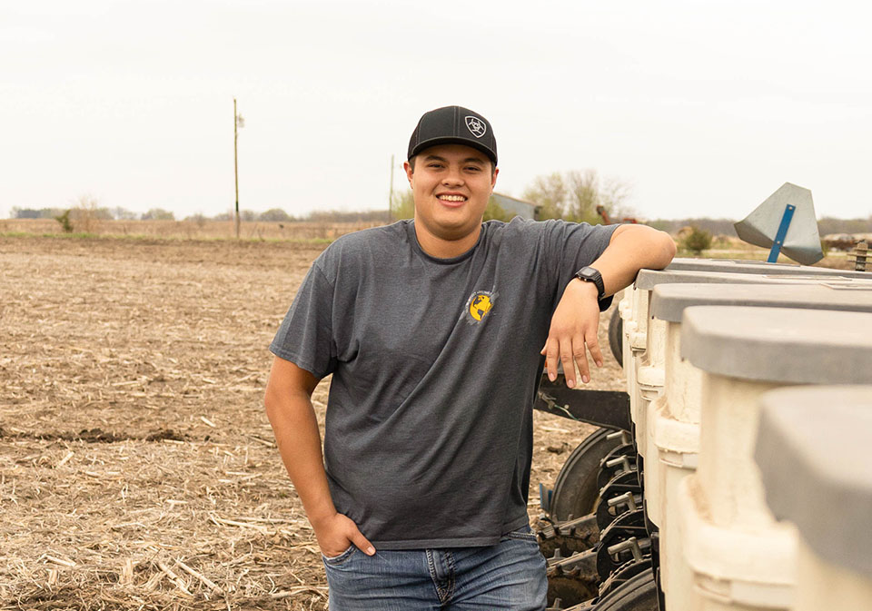 Soy squad participant next to soybean planter