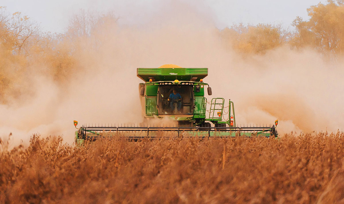 John Deere combine in soybean field during the fall