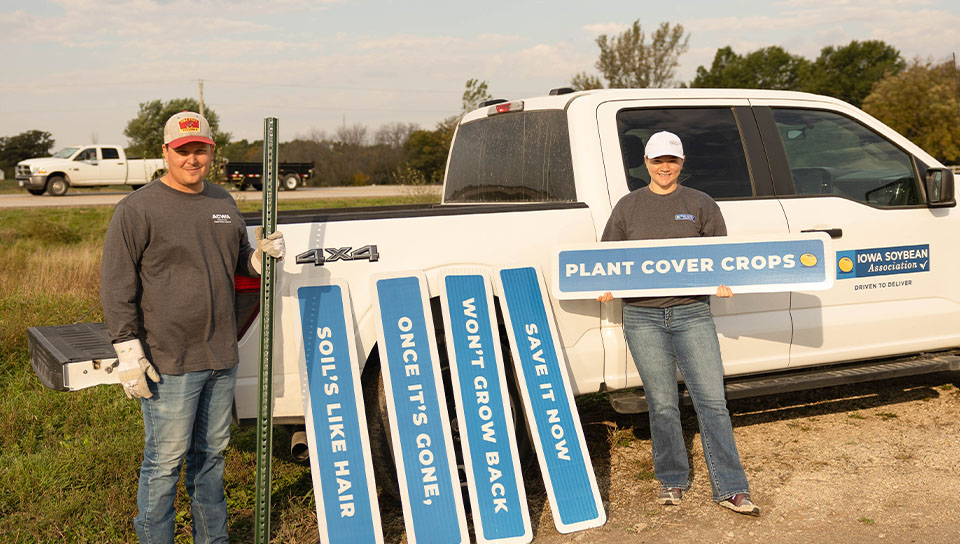 Blue signs stacked up next to truck ready for install