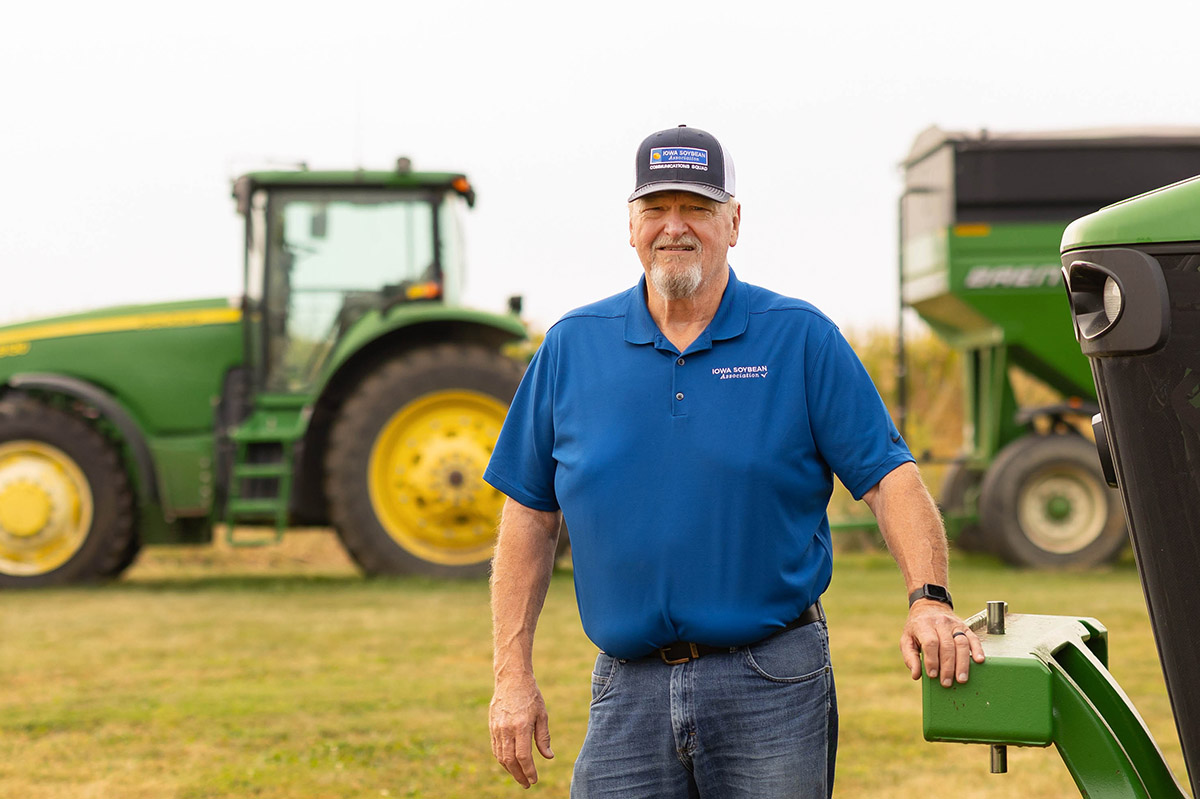 Iowa Farmer Jack Boyer Farmer standing next to John Deere tractors