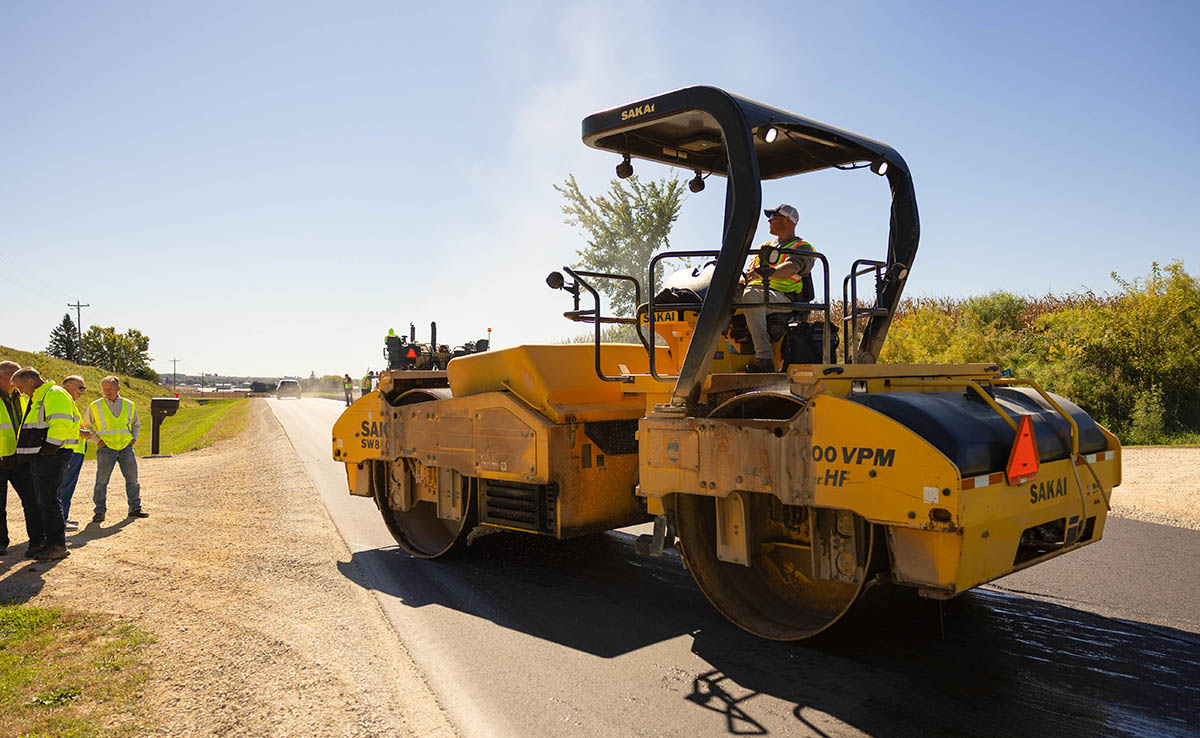 Soy Asphalt Roller People watching soy asphalt installation