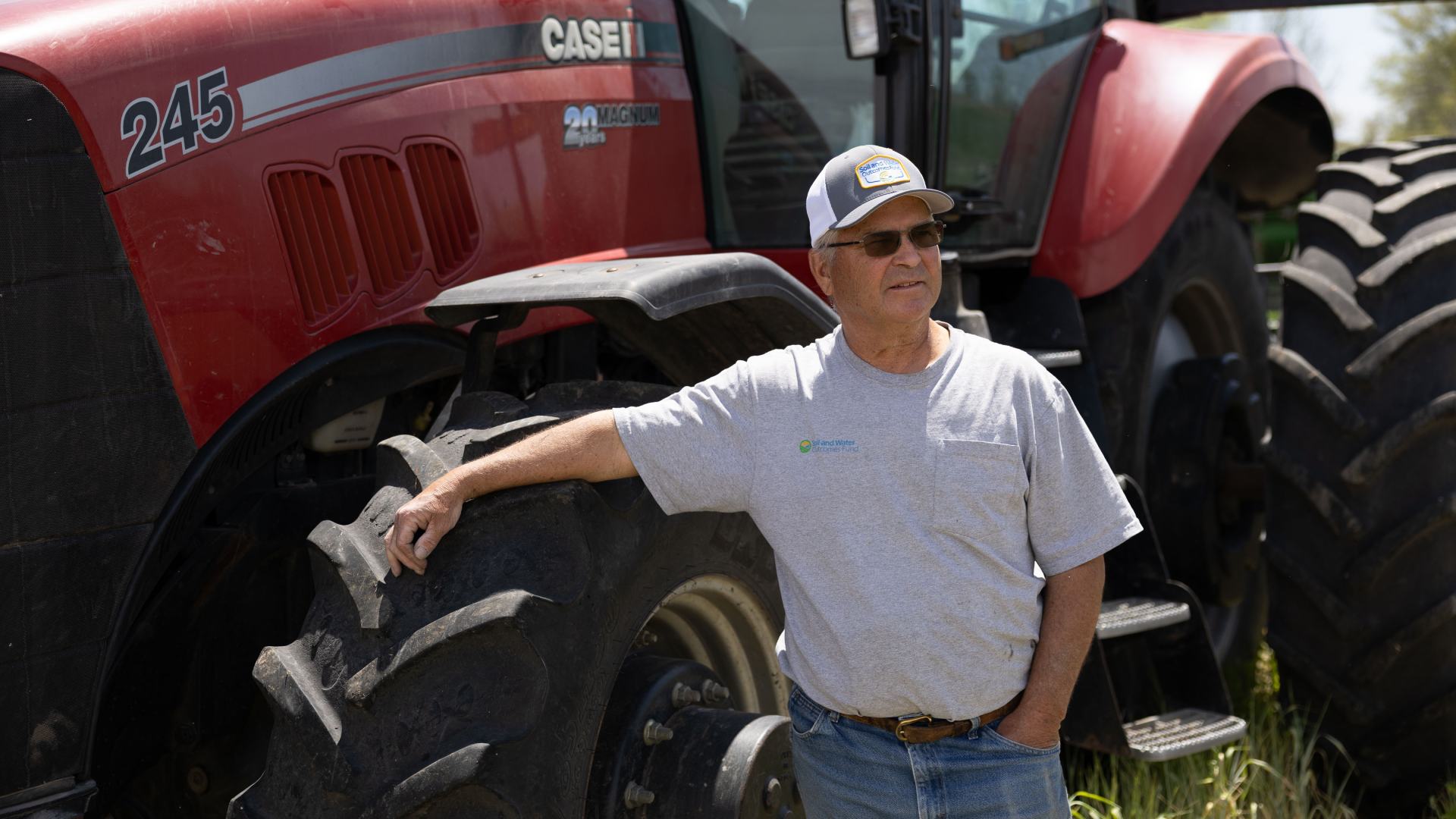 ISA President Tom Adam stands in front of his tractor
