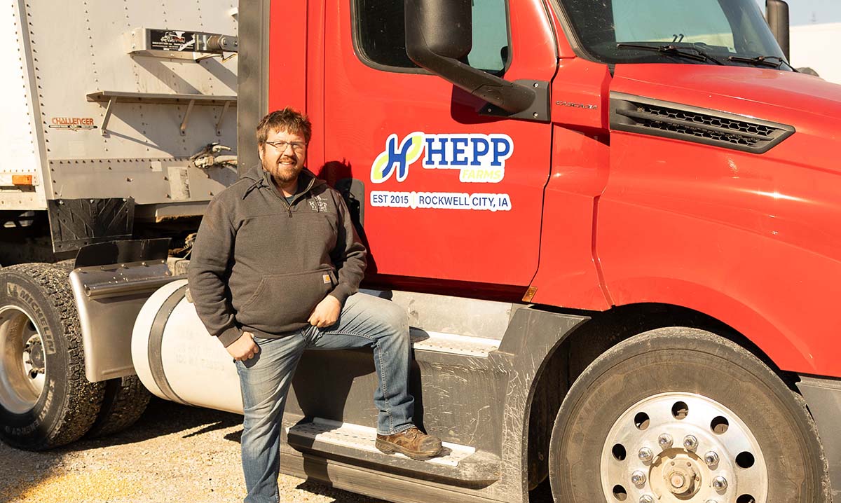 Iowa farmer standing next to semi truck
