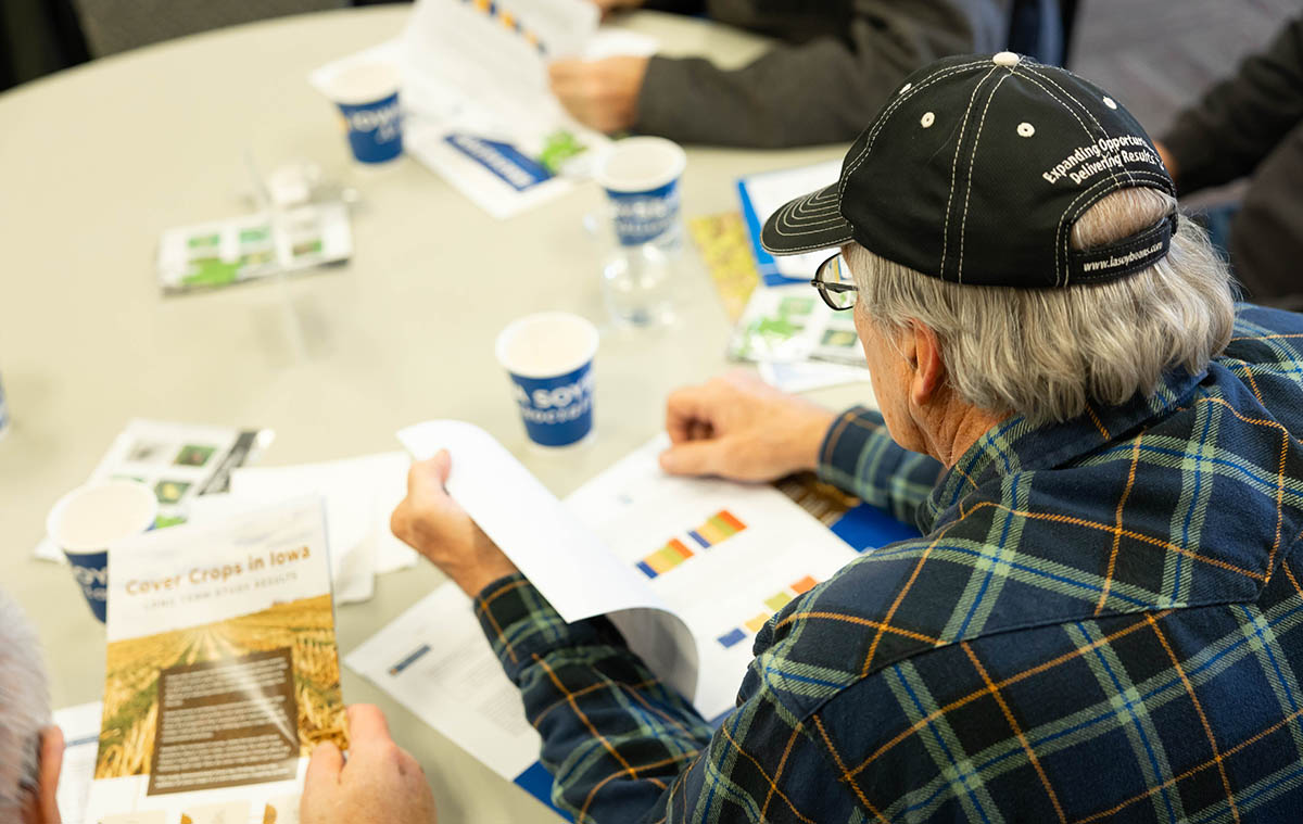 Farmers looking through soybean research
