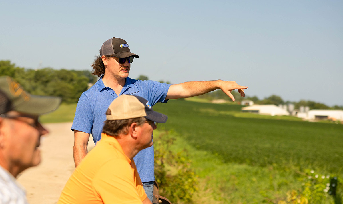 Brandon Iddings with farmers in rural Iowa