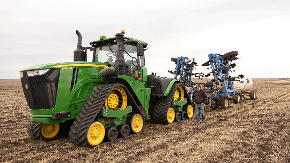 John Deere tractor pulling tanks