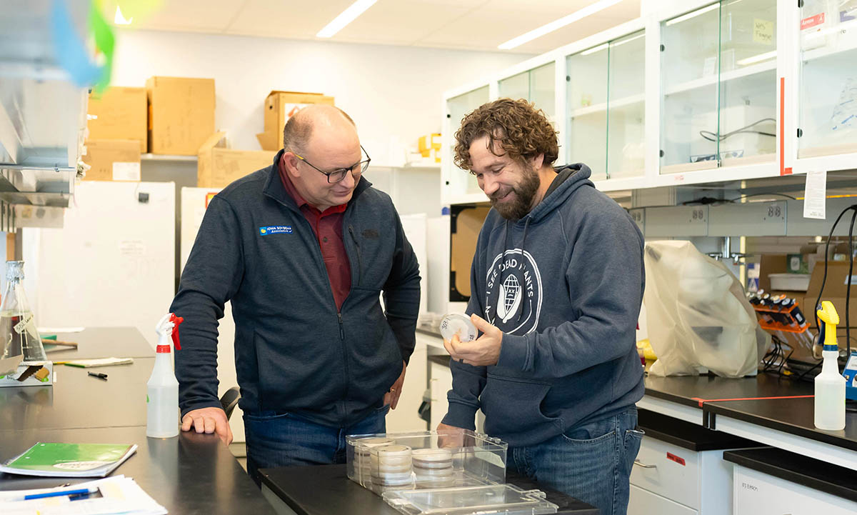 Two agricultural professionals working together in a re