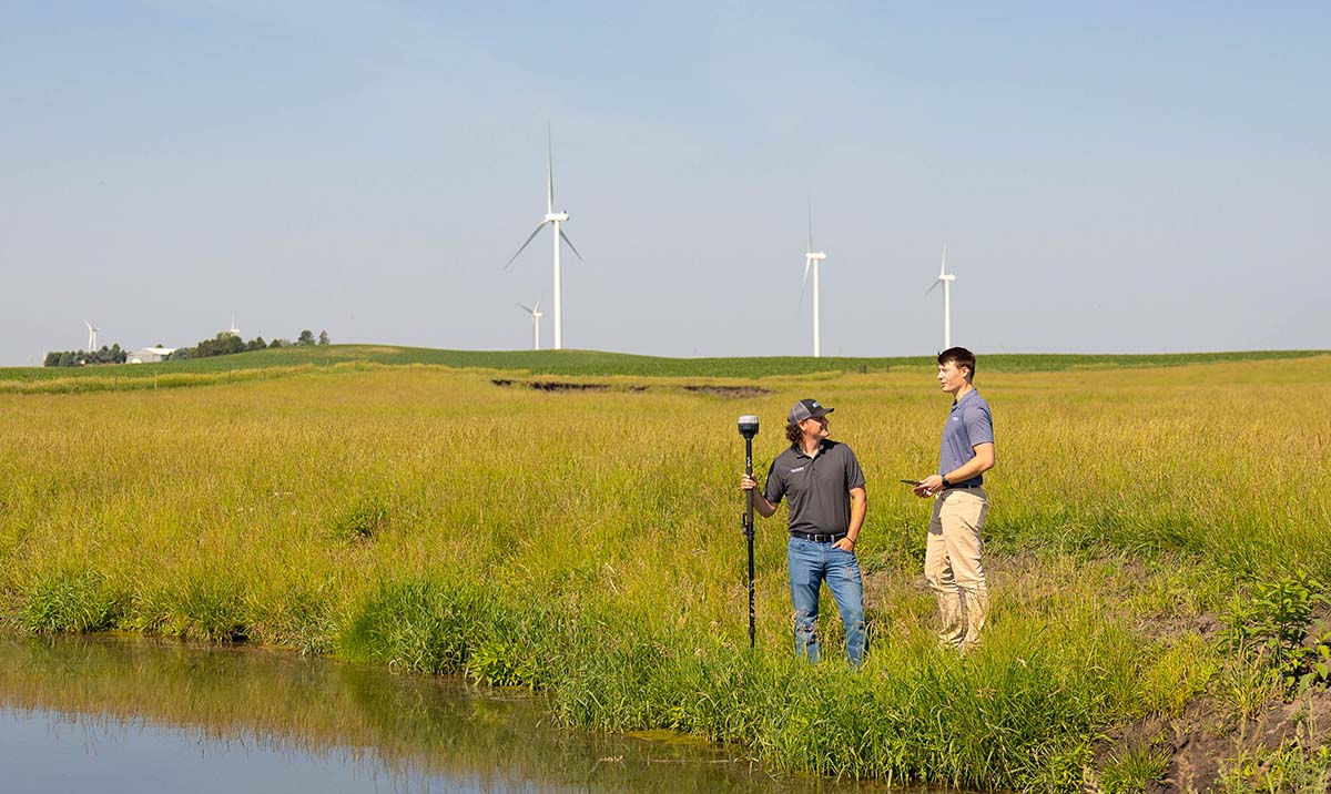Two conservation agronomists standing next to oxbow in 