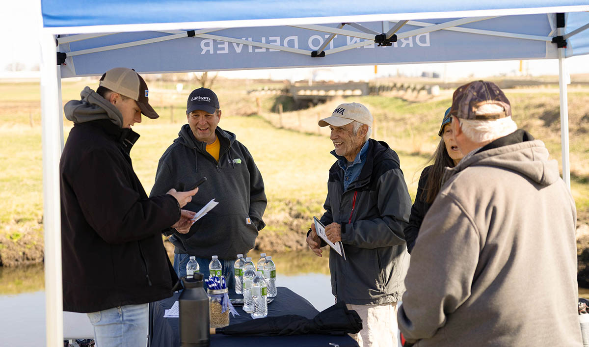 Farmers talking with conservation professional