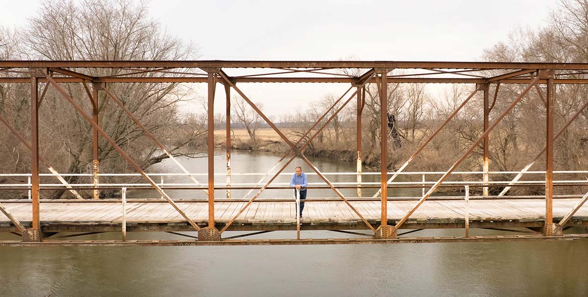 Mike Steenhoek standing on old bridge