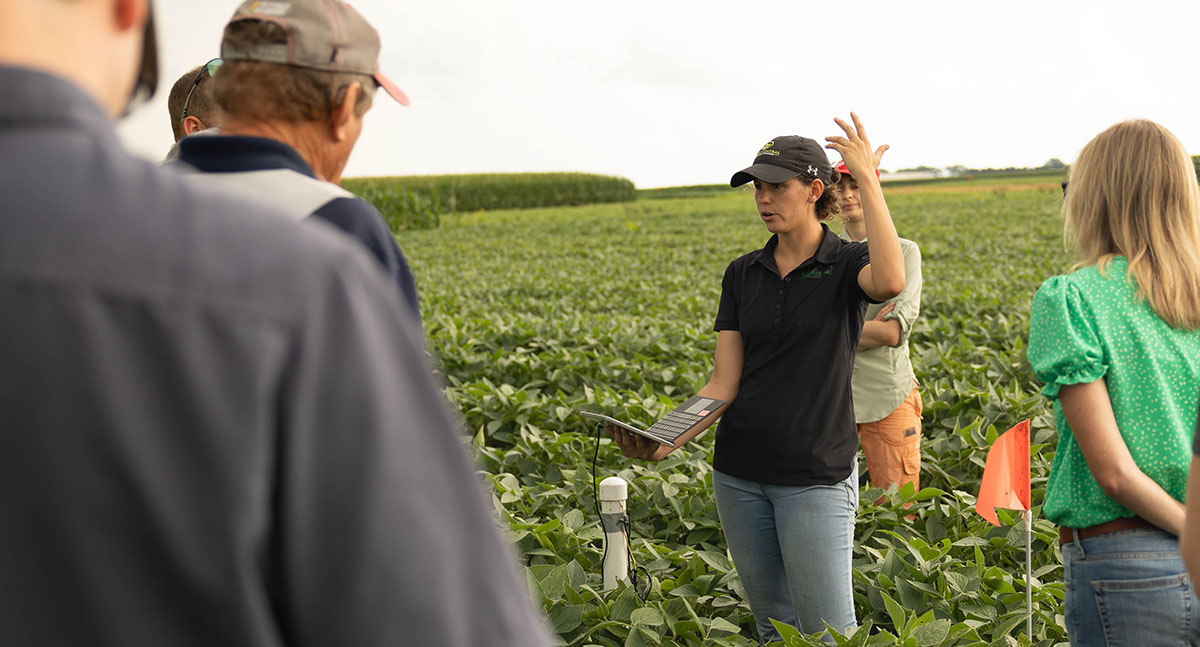 Iowa State University agronomist in a soybean field wit