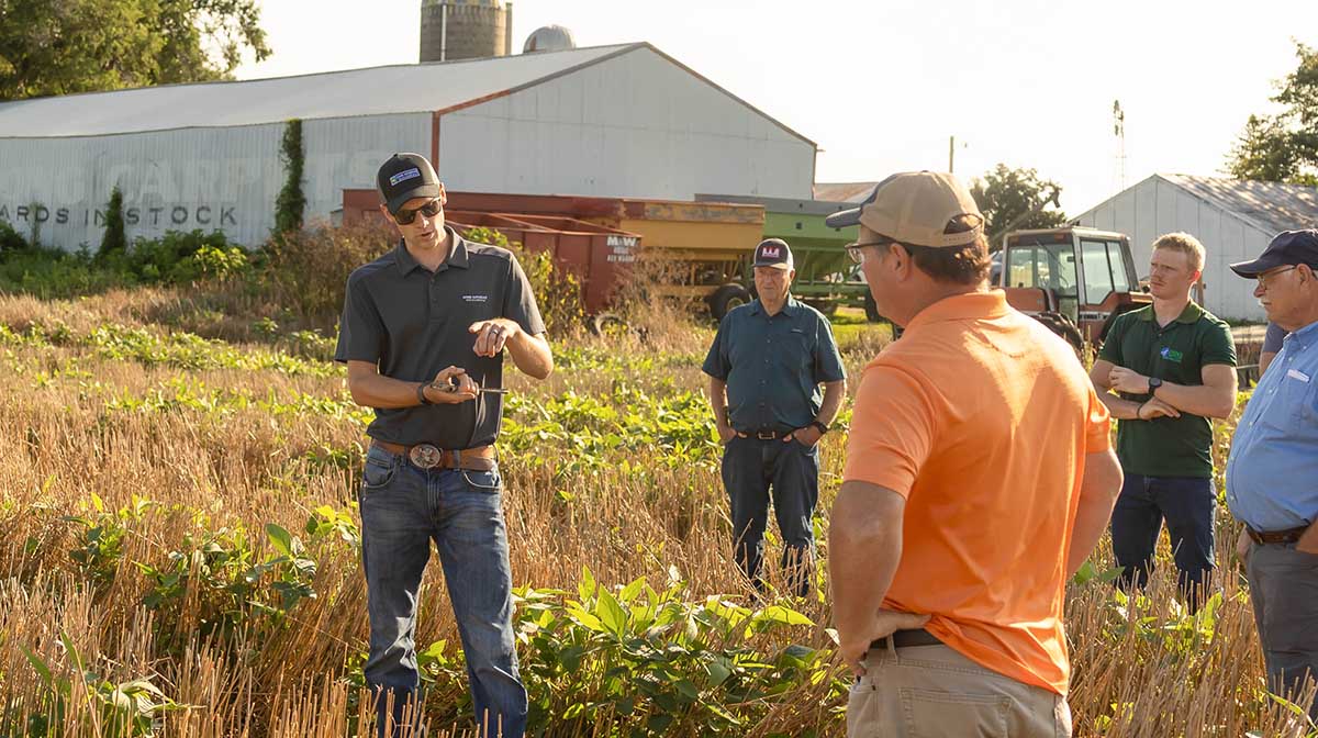 Lucas DeBruin talking with group of farmers on Experien