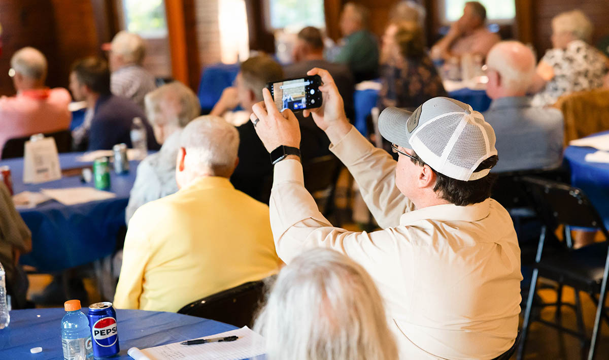 What To Expect At Summer Soy Series Farmer taking picture during Summer Soy Series