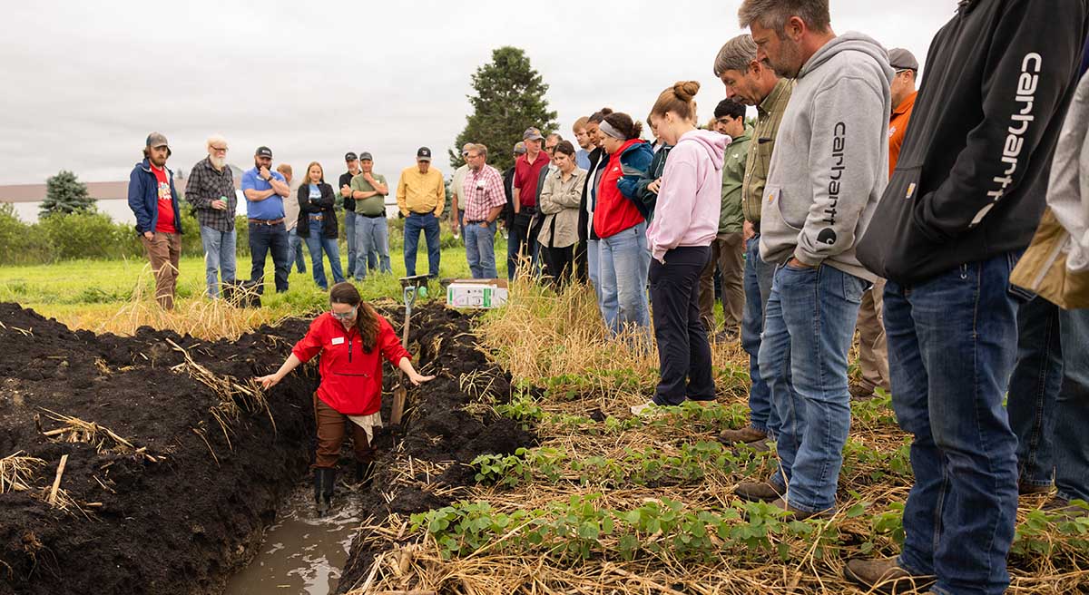 Field Day Learning Girl in muddy trench on a farm