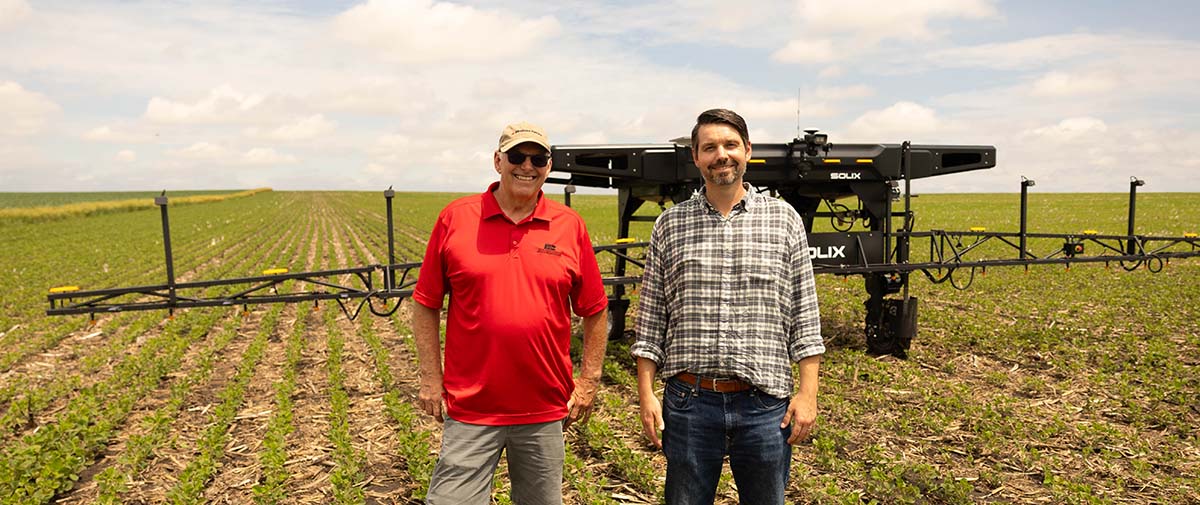 Joe Dierickx Two guys standing by autonomous sprayer