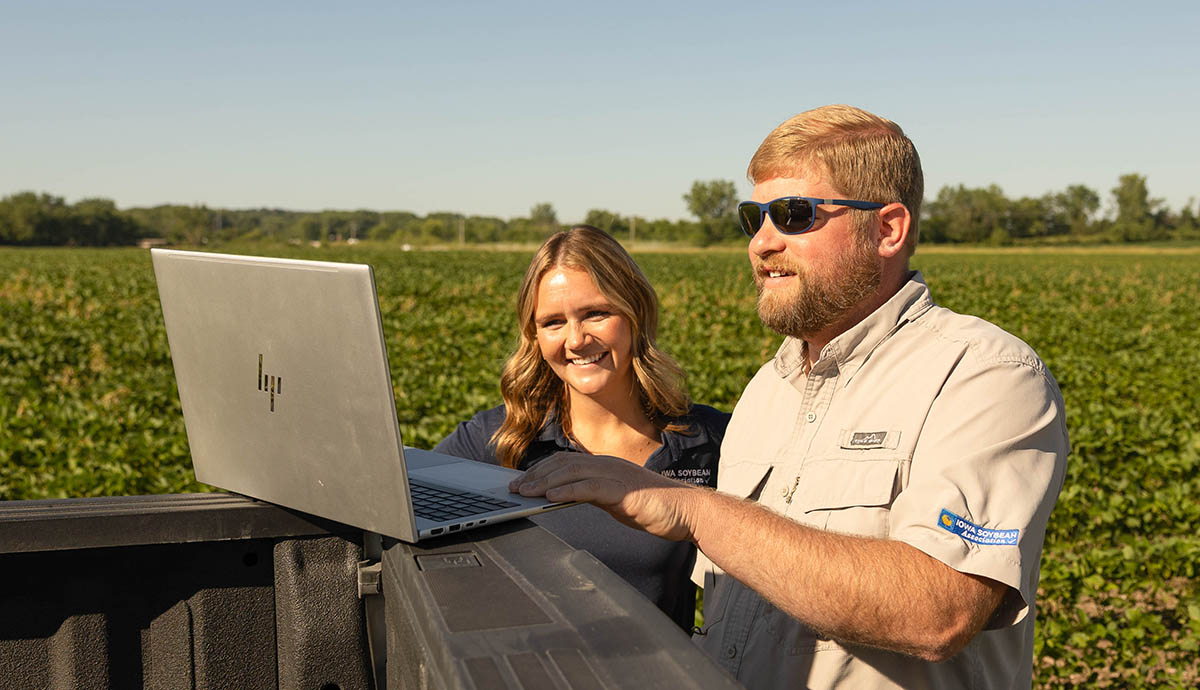 Two research agronomists on a computer