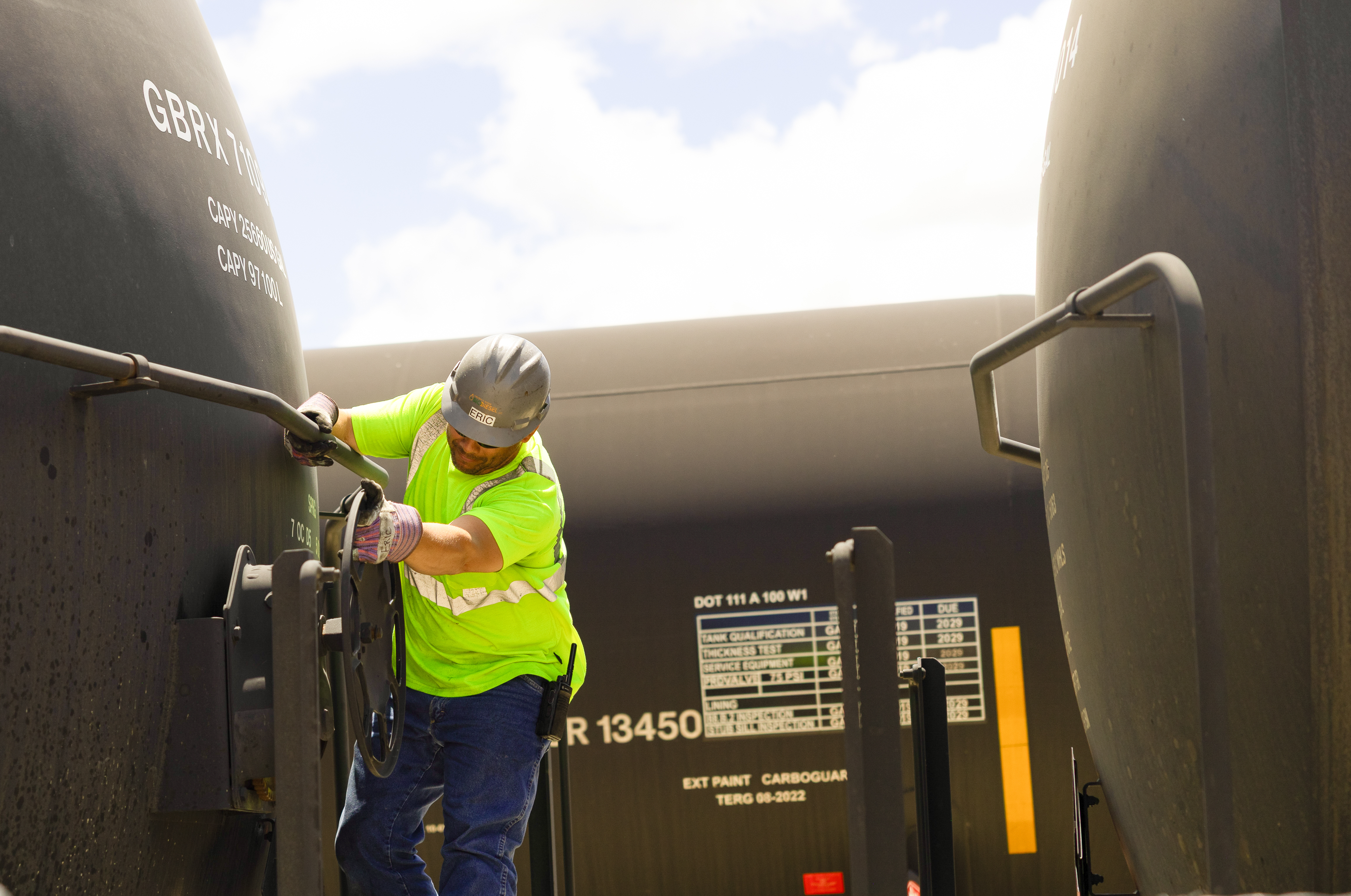Man Works on a Train Carrying Biofuels