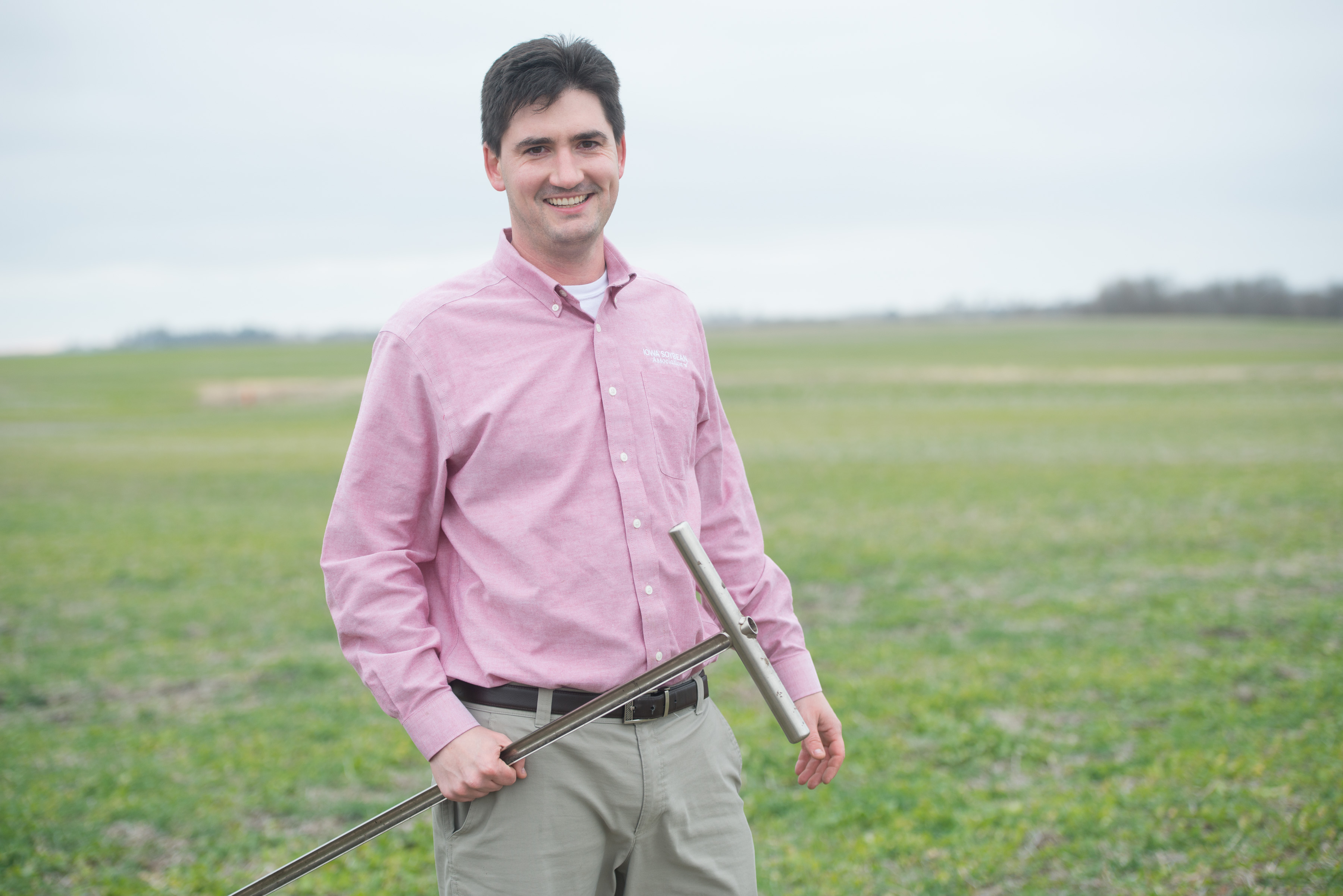 Theo Gunther stands in a field while soil testing