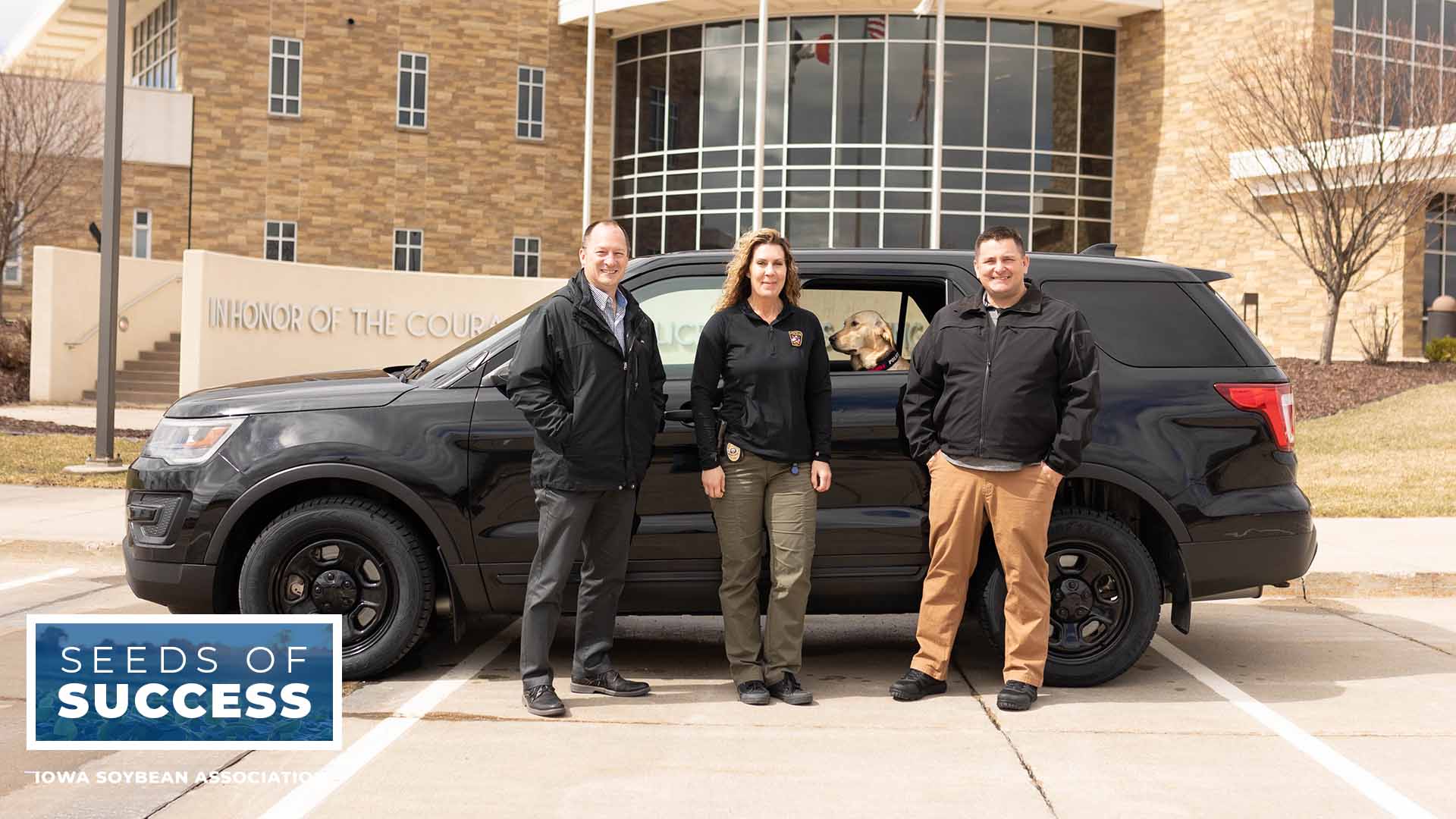 Police officials with cruiser