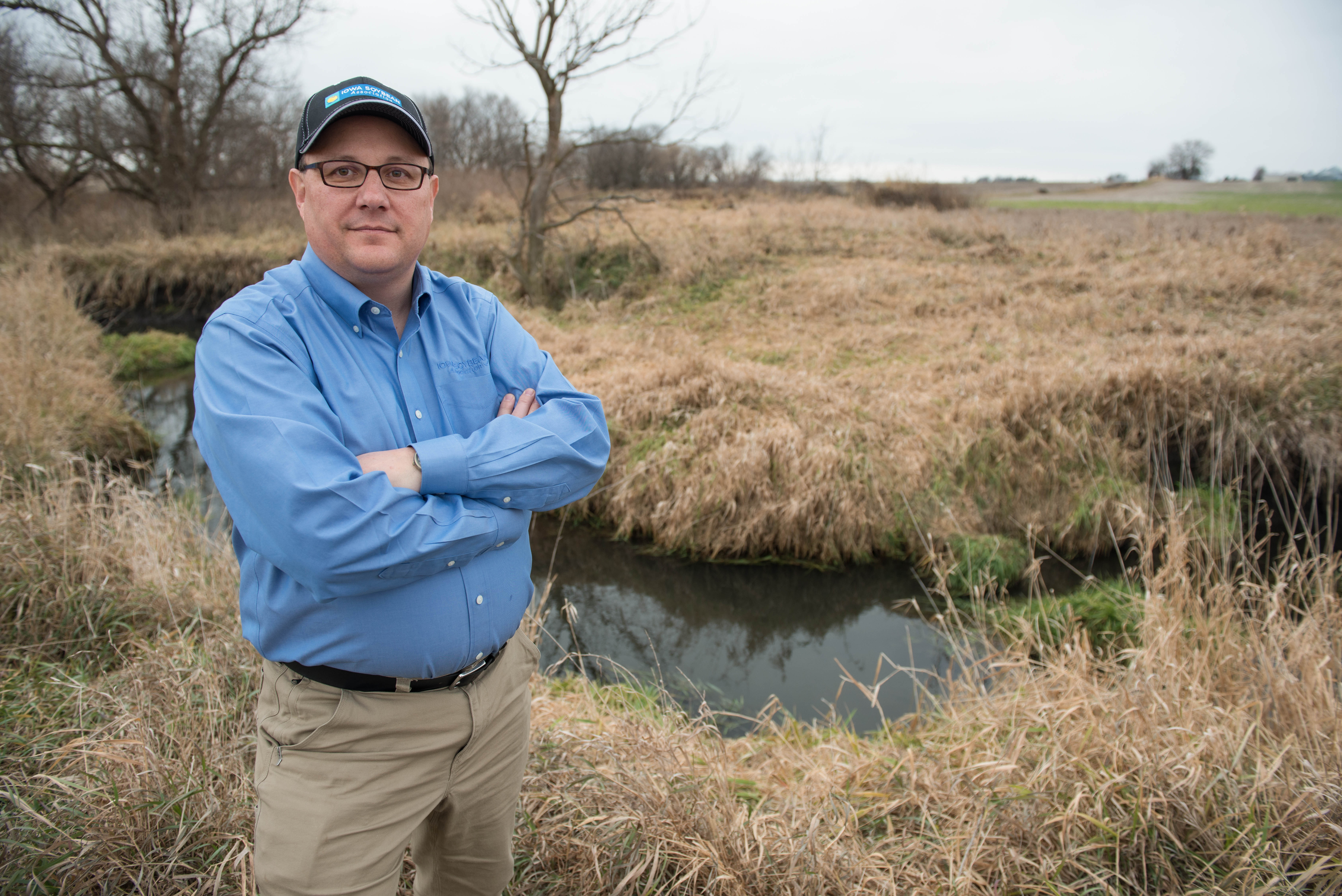 Research scientist Chris Hay stands near a water body