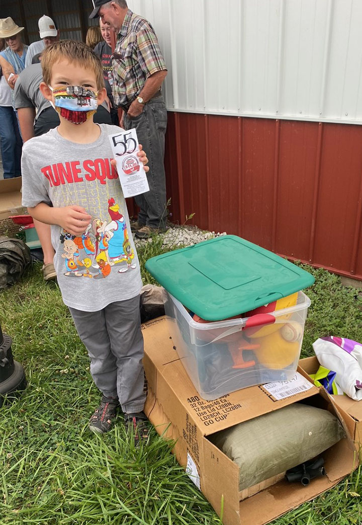 Young man standing in front of his purchase at estate auction