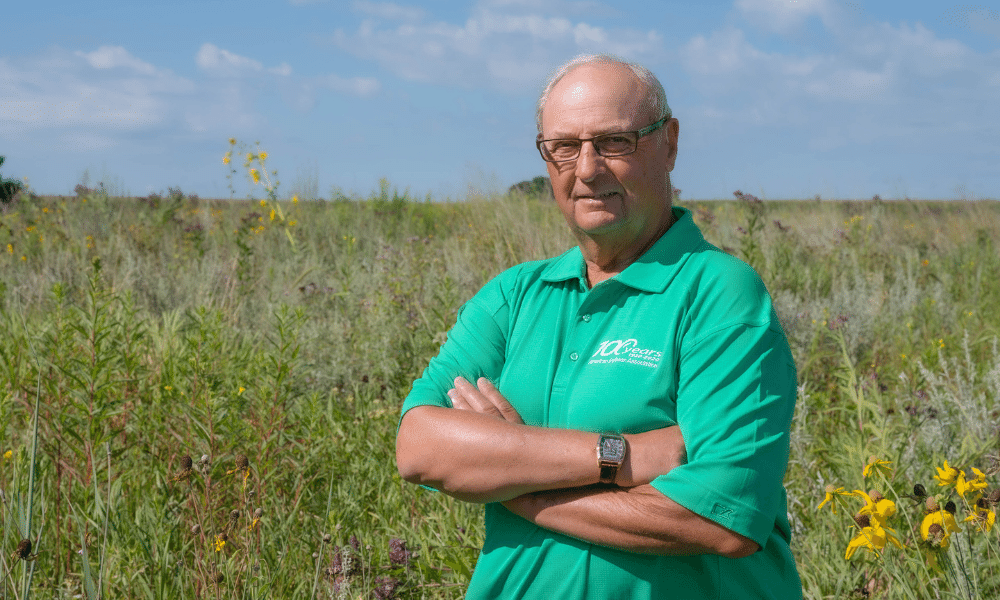 Wayne Fredericks stands in his field