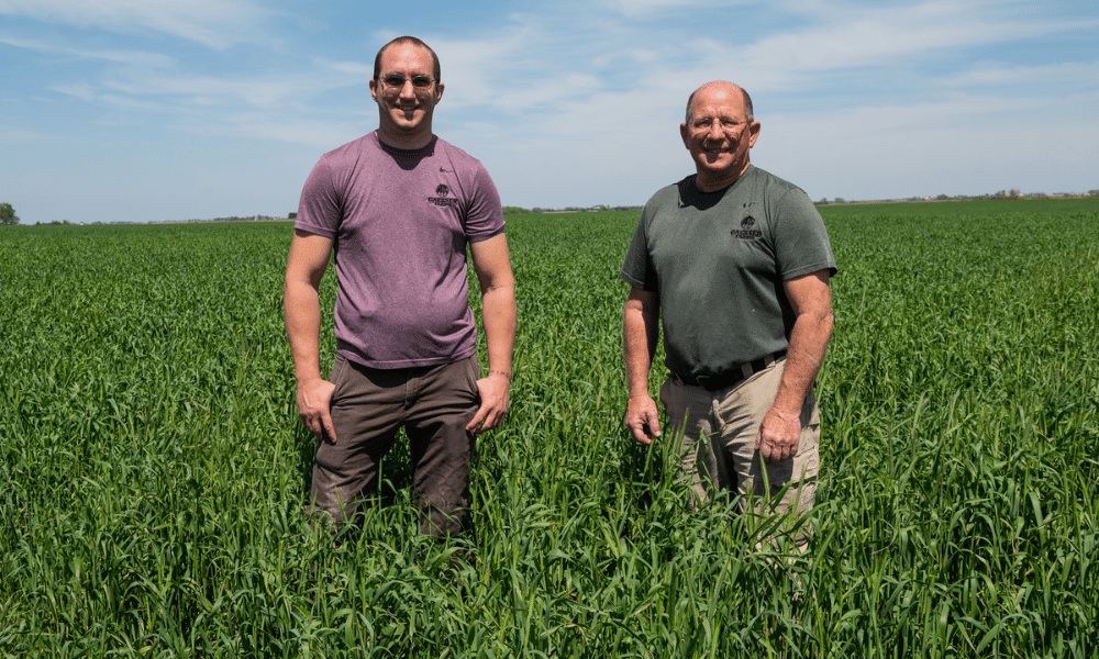 Chris and Ray Gaesser stand in a field.