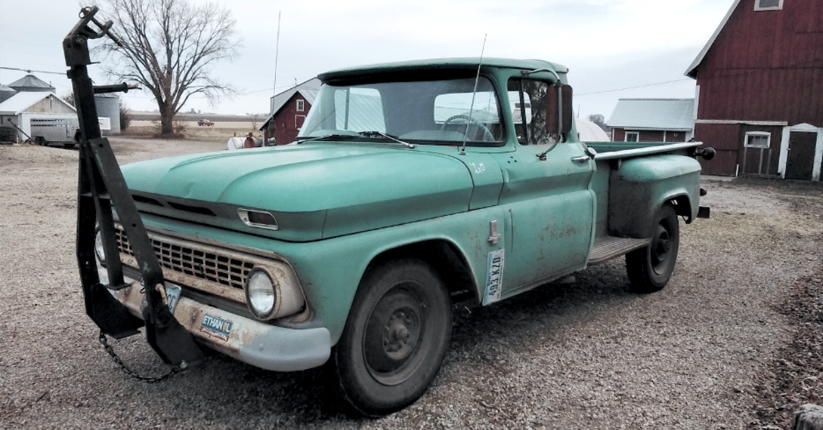 An old teal truck on the farm.
