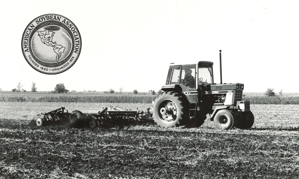 Black and white photo of an old tractor and plow