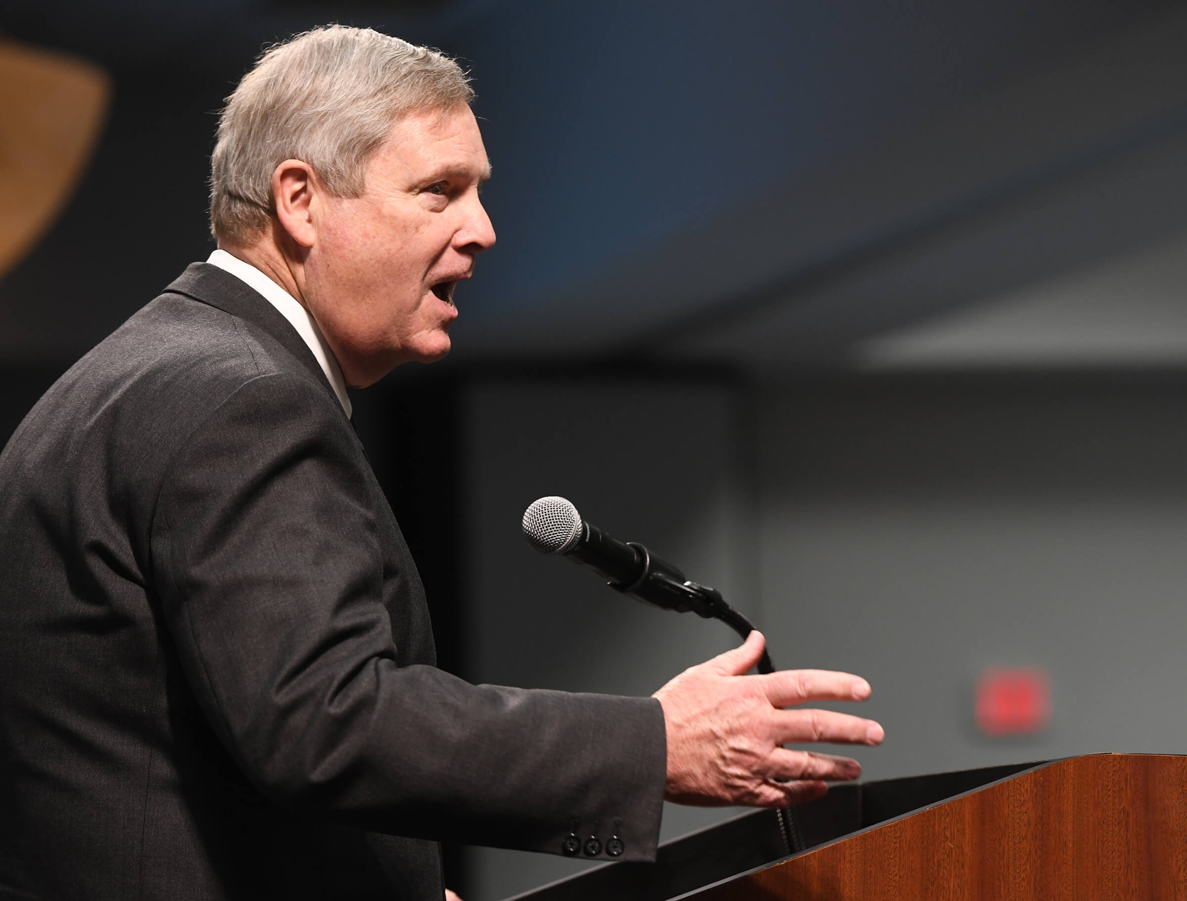 Tom Vilsack speaks passionately into a microphone
