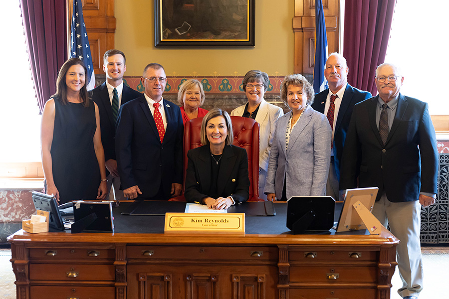 Iowa soybean farmers pose with Governor Kim Reynolds