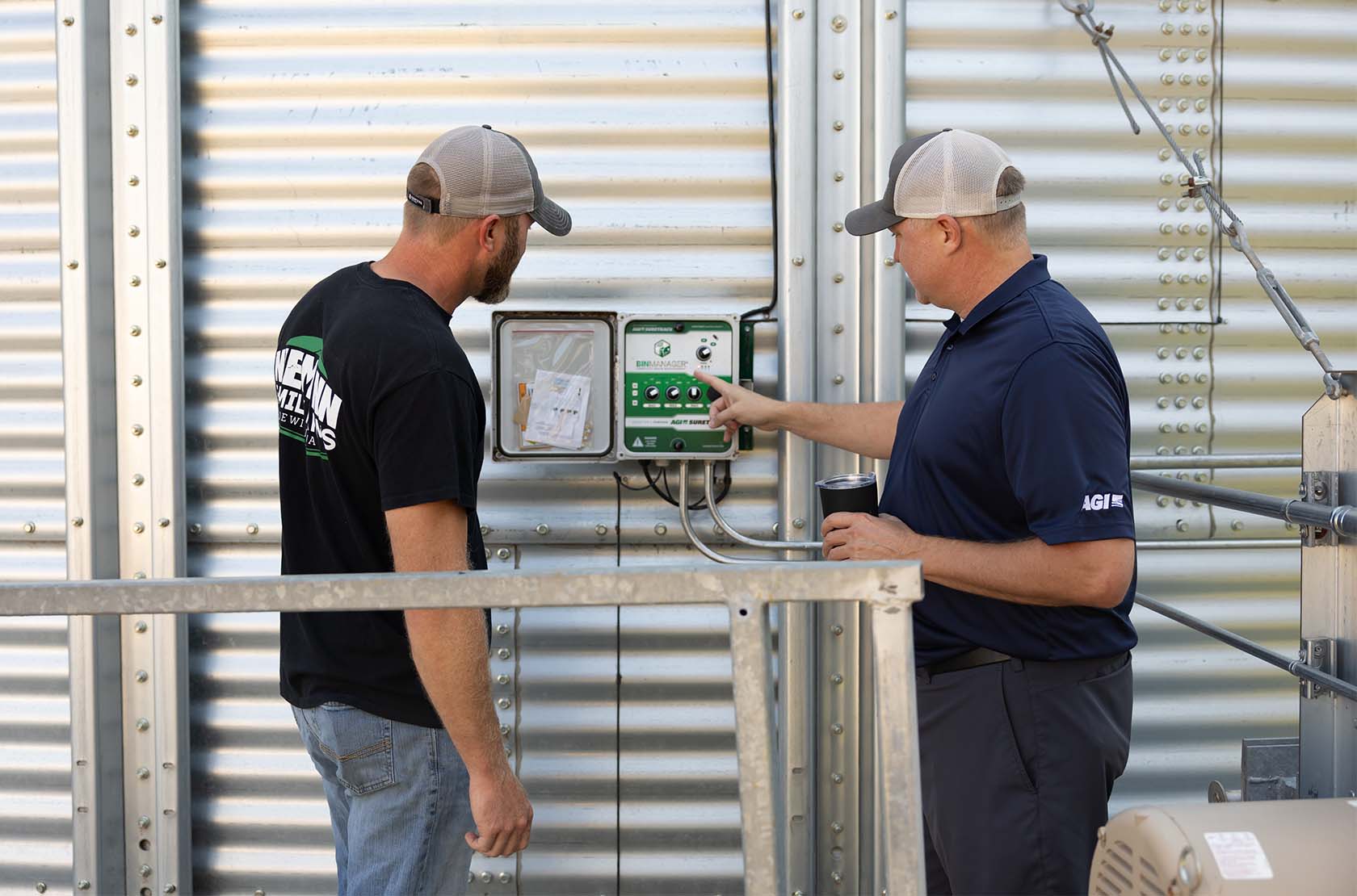 Farmers using grain drying system on a grain bin