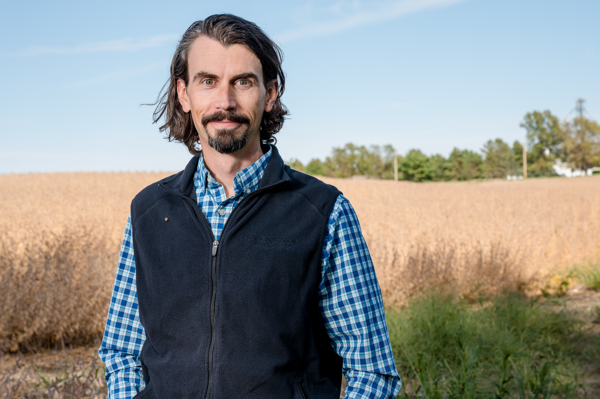 Adam Kiel stands in a field.