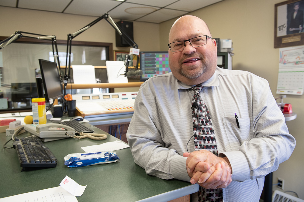 Duane Murley poses for a photo inside the radio station