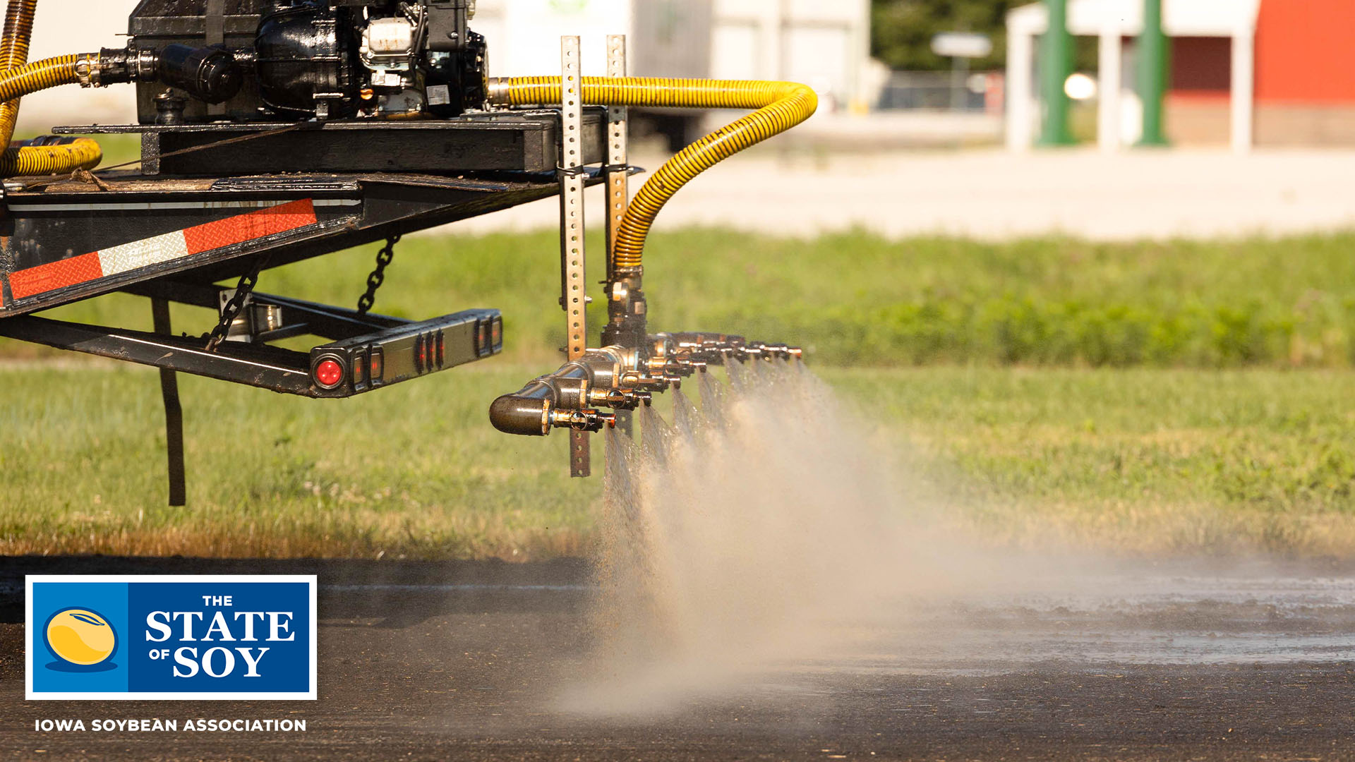 Soy-based polymer being sprayed on recycled asphalt