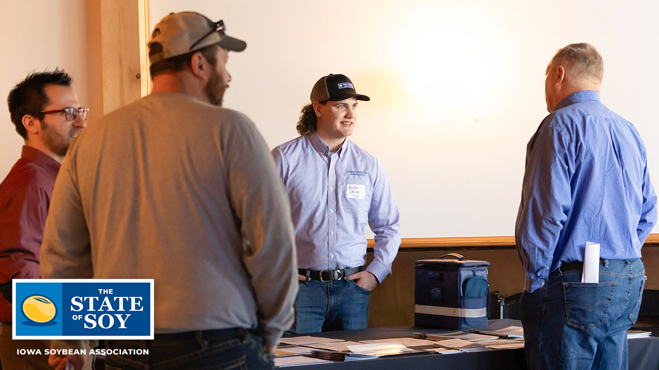 Brandon Iddings talking with an Iowa farmer