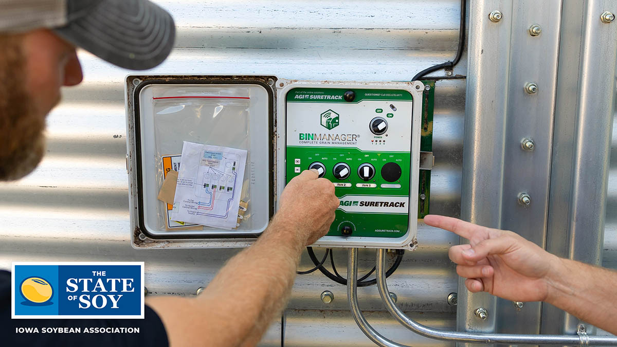 Farmer inspecting system on grain bin.