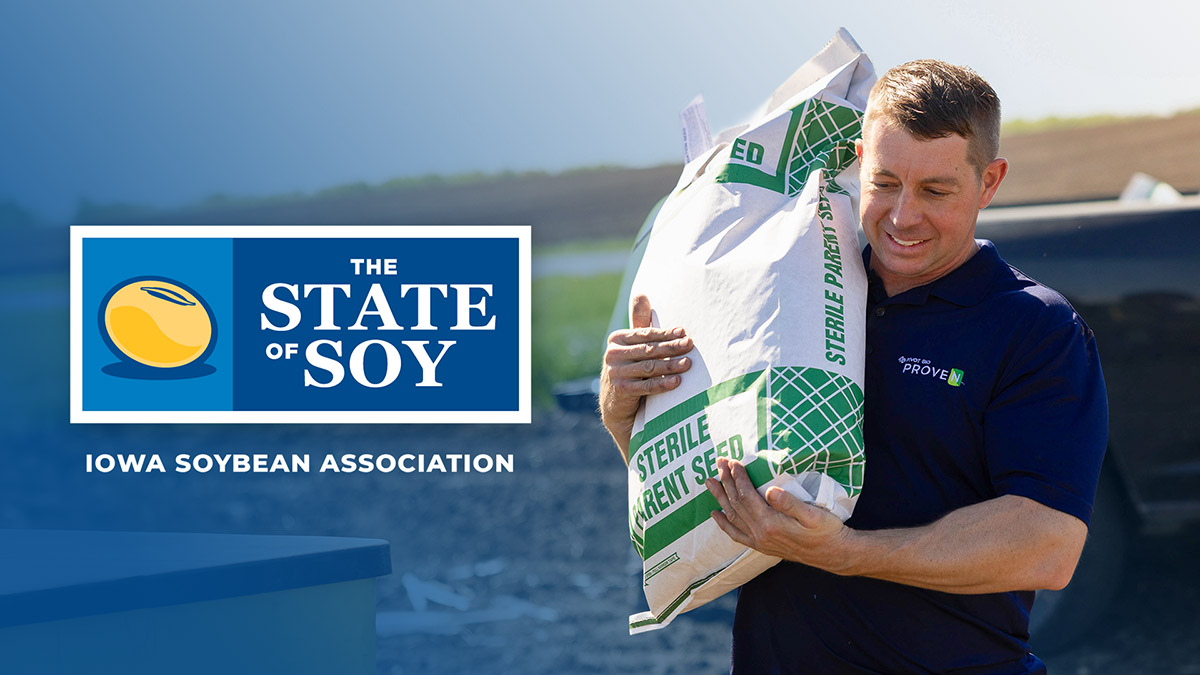 Tim Couser carrying bag of seed